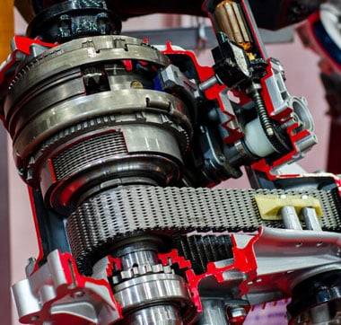 Transfer case repair work showing connected bronze metallic gears with red case exterior